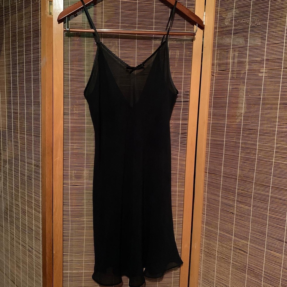 Sheer black slip with satin bows along the back. Cute black lingerie
